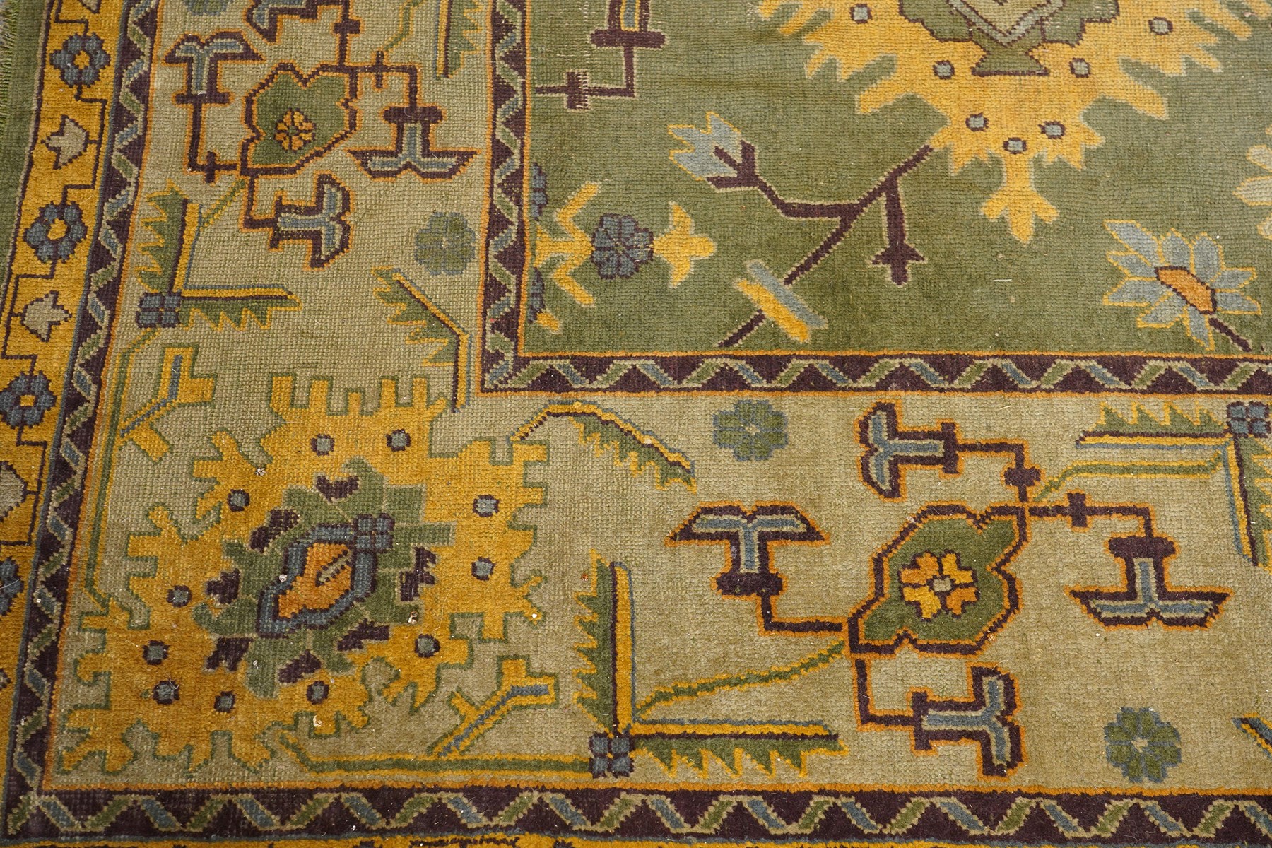 Lage Turkish Oushak green ground carpet, the field decorated with large stylised plant motifs and geometric design, the sage green guard band with further repeating foliate motifs