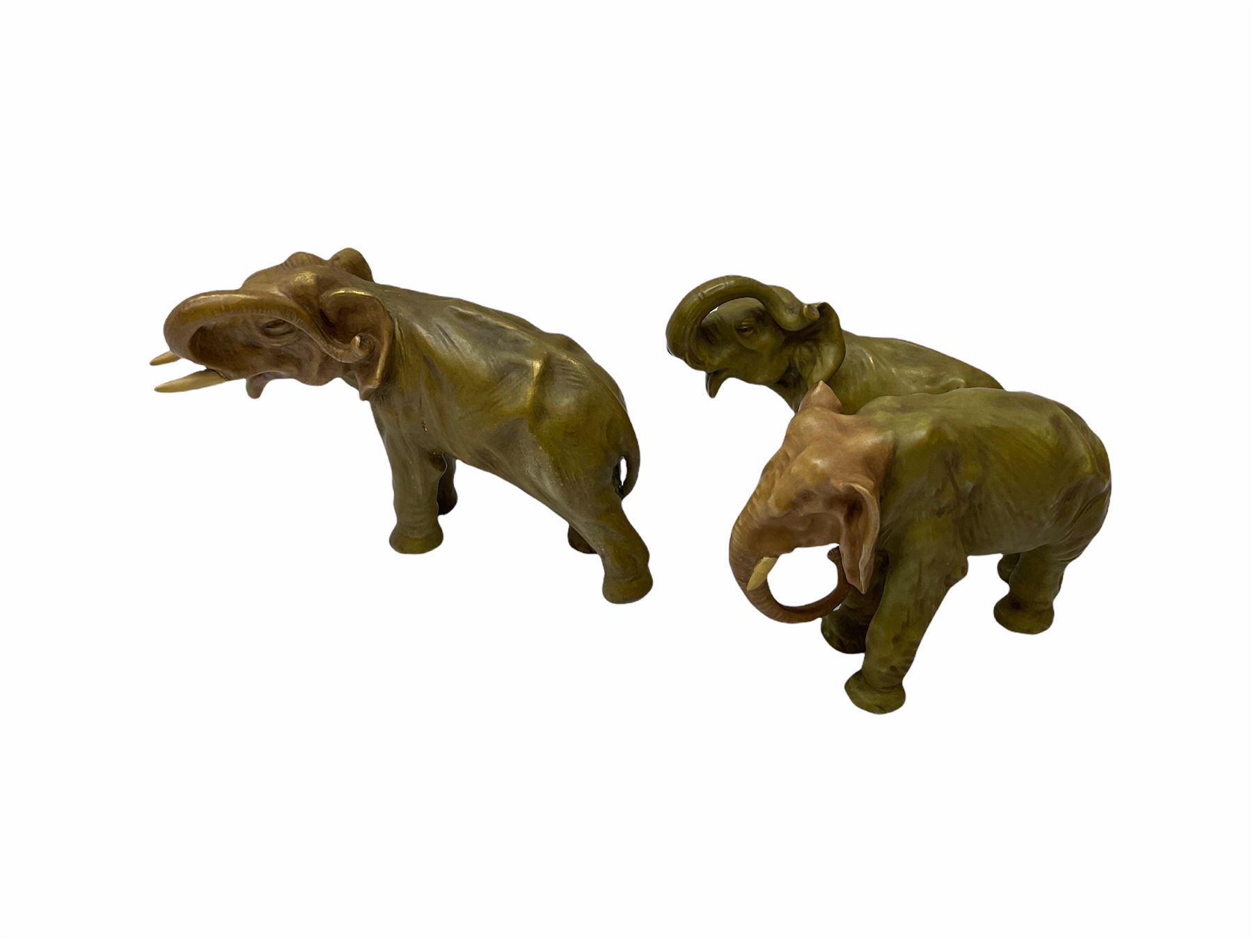 Royal Dux figure modelled as a fish seller, with applied triangle mark to the base and impressed model number 2292, H27cm, together with three Royal Dux style elephants, and a pair of Austrian Turn Wien figures, each carrying 'striker' baskets for matches. 