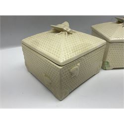 Four square honey boxes with lids,  each decorated with honeycomb pattern and finished with a bee finial