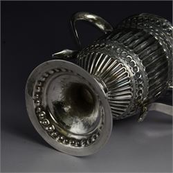 George III silver twin handled trophy cup, of typical form with twin C scroll handles and upon a domed circular foot, the body with repousse and chased fluting and C scroll decoration, with later presentation engraving to cartouche, hallmarked London 1803, maker's mark slightly rubbed but probably for Peter, Ann and William Bateman, H16cm