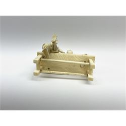 Japanese Meiji period ivory figure of a man with boy on a bench H10cm.