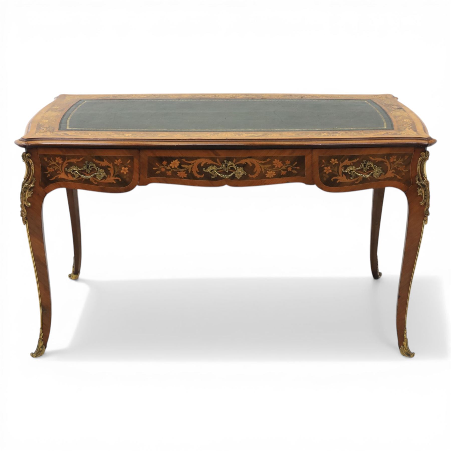 Late 19th century French kingwood and marquetry bureau plat, the serpentine rectangular top with green leather inset writing surface within crossbanded and foliate marquetry border, above a shaped frieze fitted with three drawers with floral marquetry panels and gilt metal handles, upon cabriole supports with applied gilt metal mounts and sabots