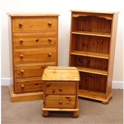  Solid pine chest, five drawers, plinth base (W66cm, H119cm, D44cm) a pine bedside chest, two drawers, turned supports (W46cm, H53cm, D40cm) and an open bookcase, three adjustable shelves, bun feet (W62cm, H122cm, D33cm)  