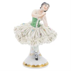 Two Continental lace figures, each modelled as a female dancer with lace skirts and lace trimmed bodice, upon a gilt detailed base, each marked beneath, tallest example H23cm