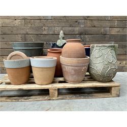 A quantity of various terracotta and glazed planters