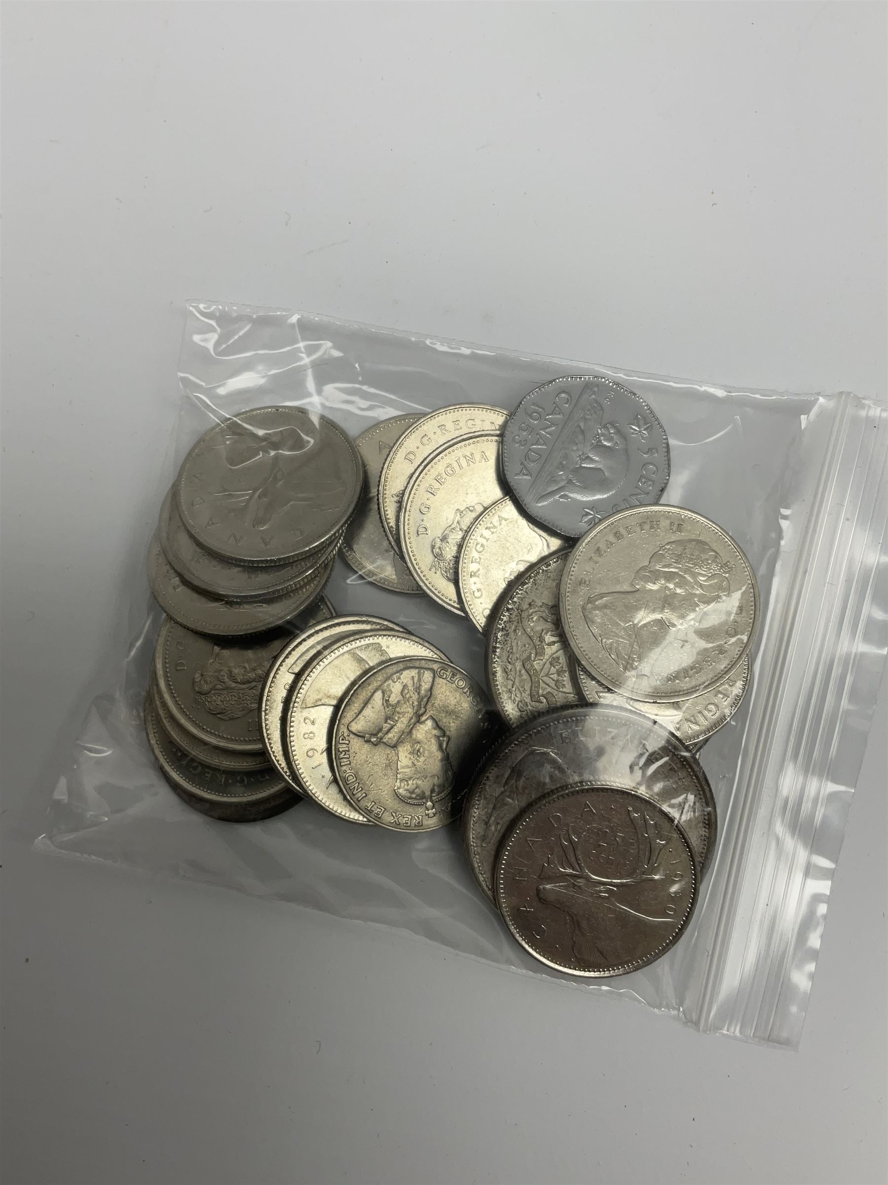 Mostly Canadian coins including 1967 six coin set, various Canadian 50 cent coins, various nickels, Royal Canadian Mint 1990 specimen coin set in blue folder with outer sleeve, various Canadian dollars etc, in folders and loose