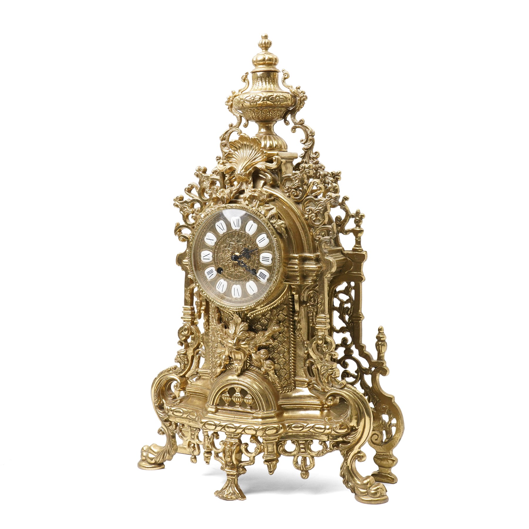 19th century design mantel clock, the brass dial with porcelain numerals, bell strike in brass case of rococo design with urn finial H60cm