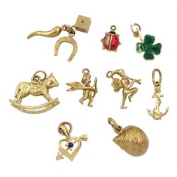Nine 9ct gold charms including fairy, cherub, rocking horse, four leaf clover and anchor