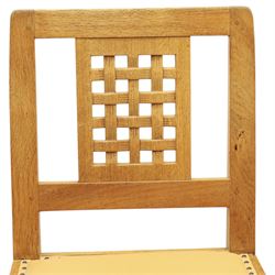 Mouseman - set of eight light oak dining chairs, each with lattice panel back and tan leather upholstered seat, raised on octagonal front legs joined by stretchers, with signature carved mouse, by the workshop of Robert Thompson, Kilburn