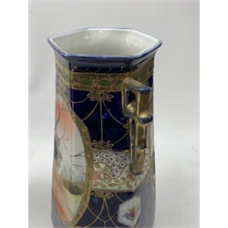 A pair of Japanese Nippon Kinjo vases, of tapering hexagonal form with twin stylised handles, the cobalt blue ground with oval hand painted panels to front and verso depicting landscapes, further detailed with smaller floral bands and panels and heightened with gilt, each with mark beneath, H30.5cm.  