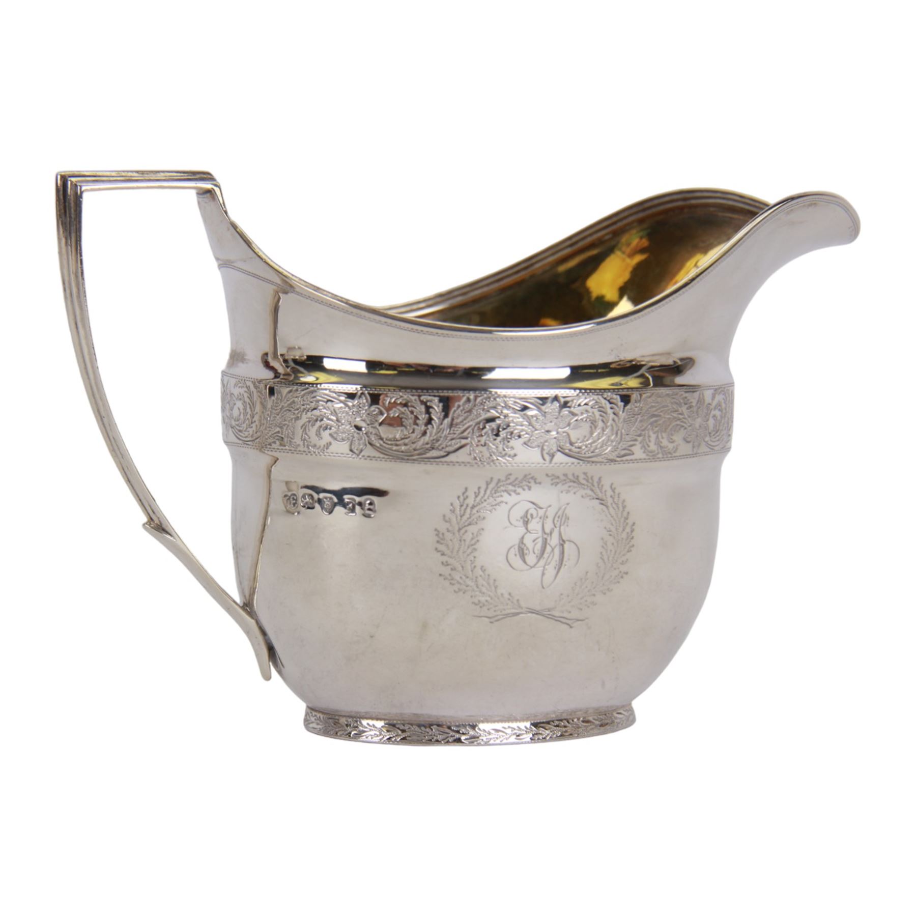 George III silver three piece tea service, comprising teapot with ivory scroll capped curved handle and ivory finial to the hinged cover, twin handled open sucrier with gilt interior, and cream jug with gilt interior, each of oval form with rounded sides, the bodies engraved with central monogram within a seaweed wreath, between engraved foliate bands, hallmarked John Emes, London 1801, teapot including handle H17cm

This item has been registered for sale under Section 10 of the APHA Ivory Act