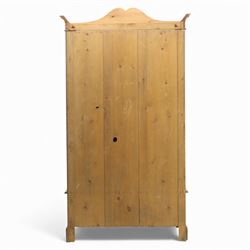 Victorian satin walnut single door wardrobe, shaped cavetto cornice above a central arched mirrored door flanked by recessed panelled sides, the interior fitted with hanging space and later added corner shelves, over a single long drawer with brass handles, on a plinth base