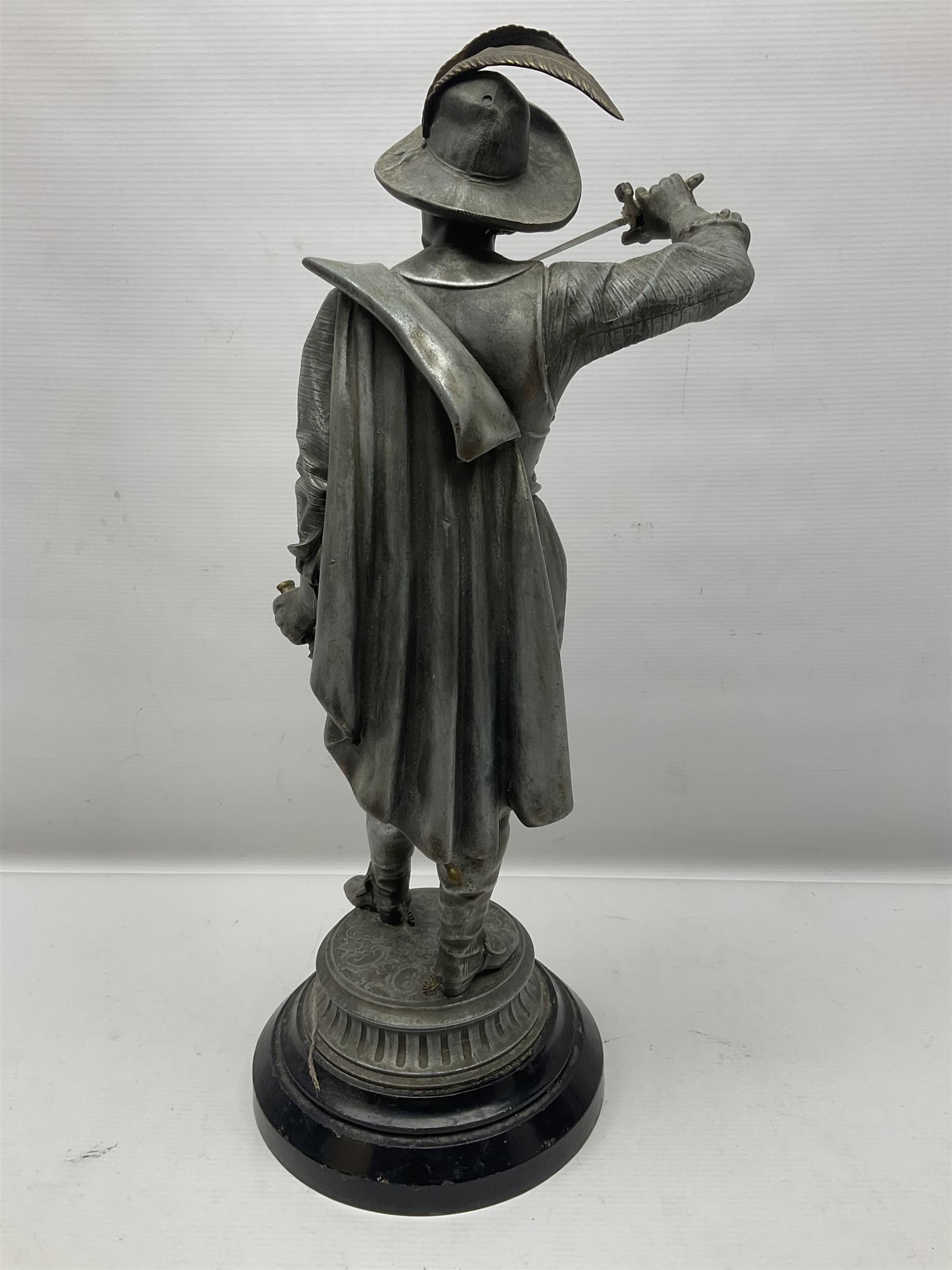 Spelter figure modeled as Cavalier with a raised sword, upon a circular base, H52cm