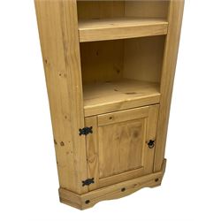 Pine media or television cabinet, enclosed by single glazed door (W56cm, H82cm, D43cm); pine corner cupboard, three shelves over single cupboard (W76cm, H188cm); pine two-tier plate rack with shaped frieze and uprights (W113cm, H107cm)