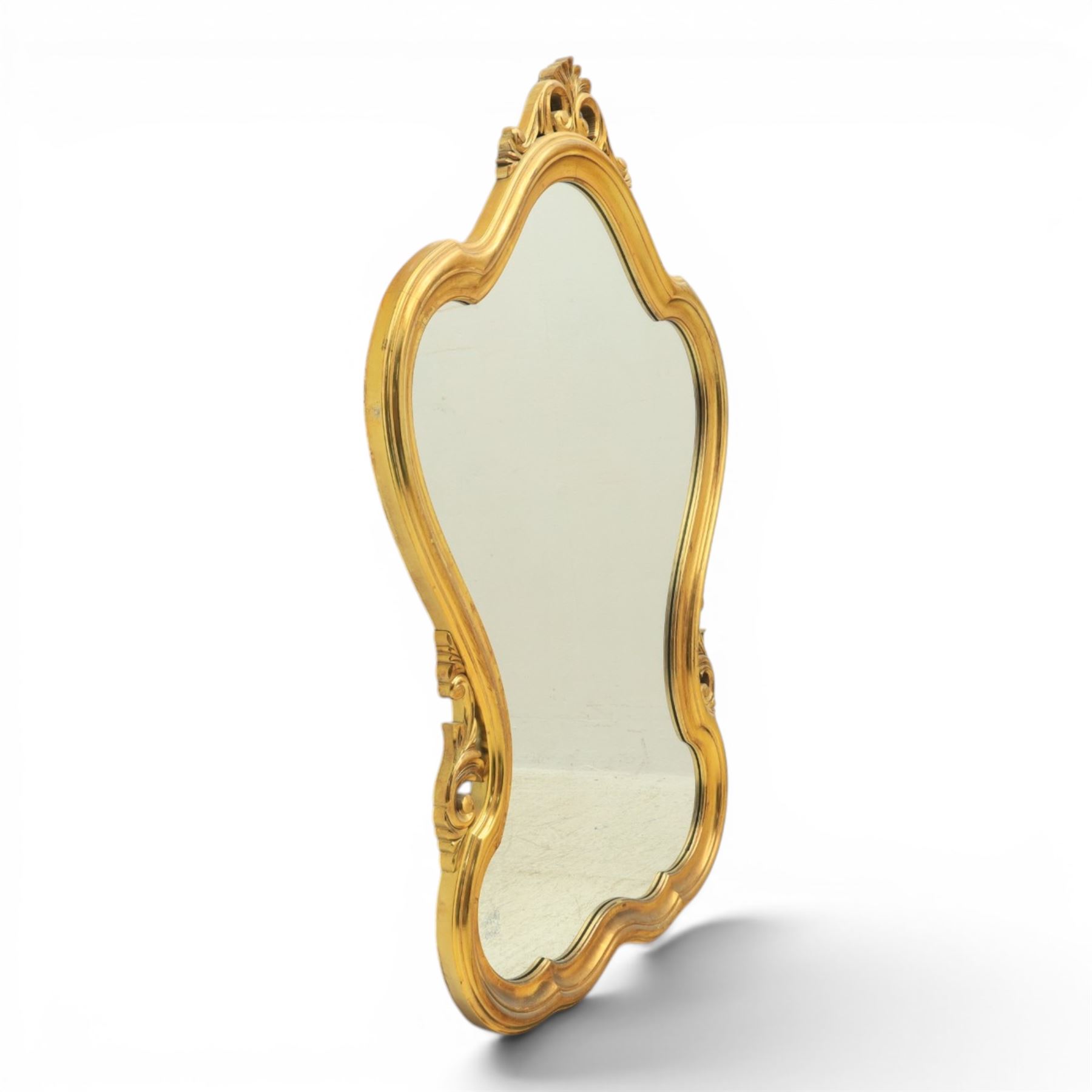 Rococo design gilt wall mirror, shaped and moulded frame, serpentine lower apron, enclosing a plain mirror 