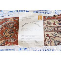 Persian ivory ground Kashan carpet, the busy field decorated with a central floral pole medallion with matching spandrels, the field profusely decorated with scrolling foliate motifs, the crimson guard stripe with repeating scrolling palmettes