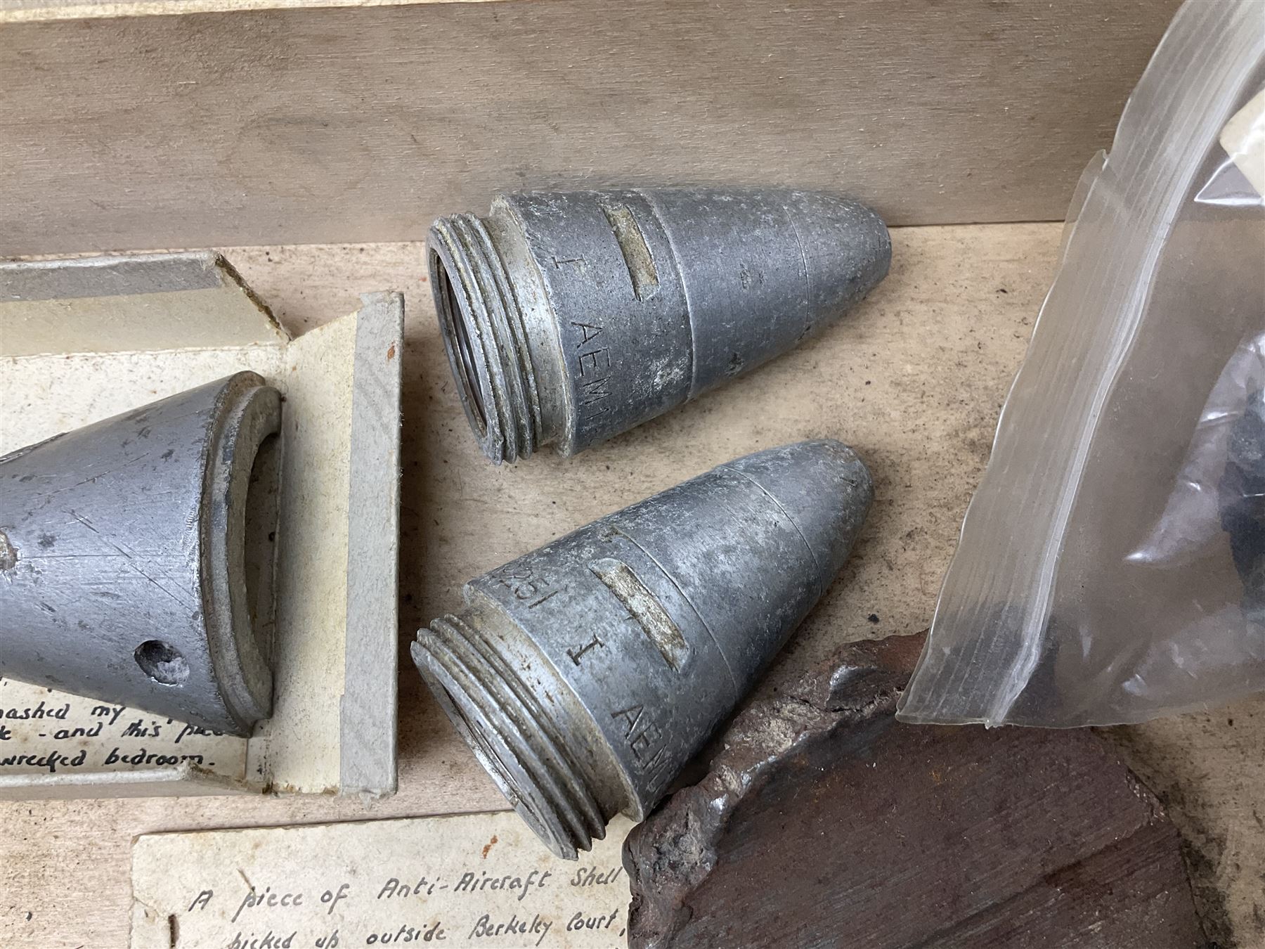 Small collection of WW2 shrapnel and German and British shell parts, most with manuscript details of where and when found including London, Leeds, Bristol, Linton-on-Ouse etc