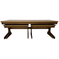 Mid-20th century teak nest of three tables, rectangular coffee table with two side tables, on shaped end supports