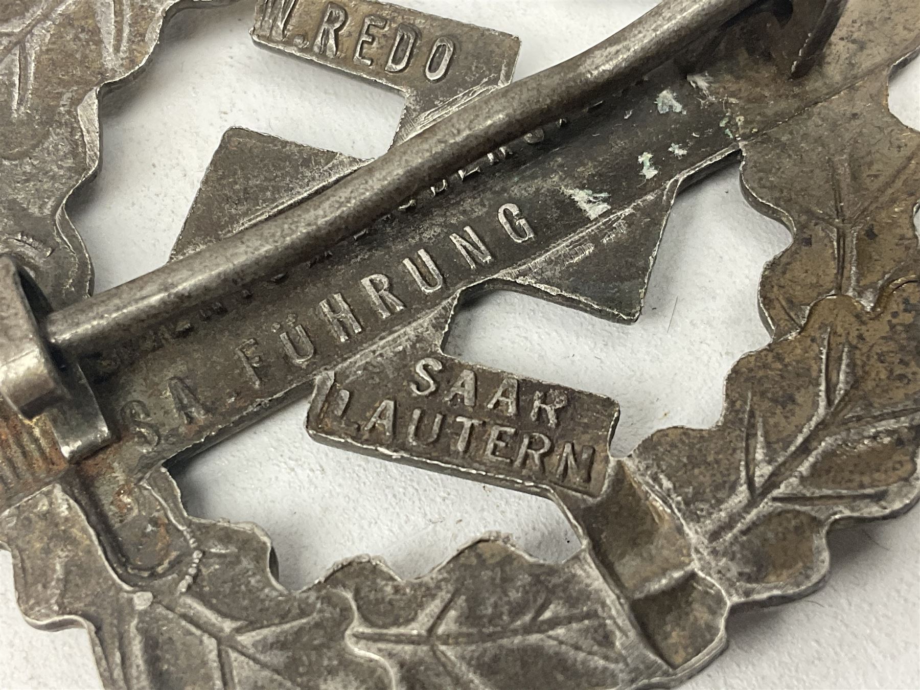 Two WW2 German Sports badges - SA sports badge marked verso 'W.Redo Eigentum D. Obersten SA. Fuhrung Saar Lautern'; and DRL sports badge marked verso 'Wernstein Jena D.R.G.M. 35269' (2)