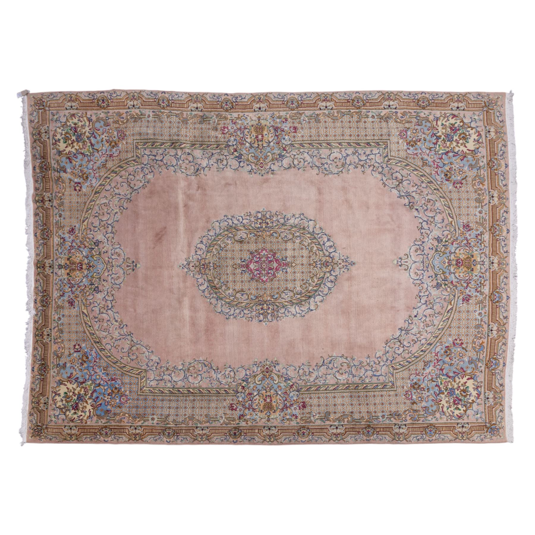 South East Persian Kirman hand-knotted rug, pale blush field with central scalloped medallion within an elaborate scalloped cartouche, spandrels filled with fine scrolling vine-work, palmettes and floral sprays, enclosed by wide and narrow borders in soft tones of blush pink, ivory, powder blue, sage green and pale gold, with cotton fringe ends 