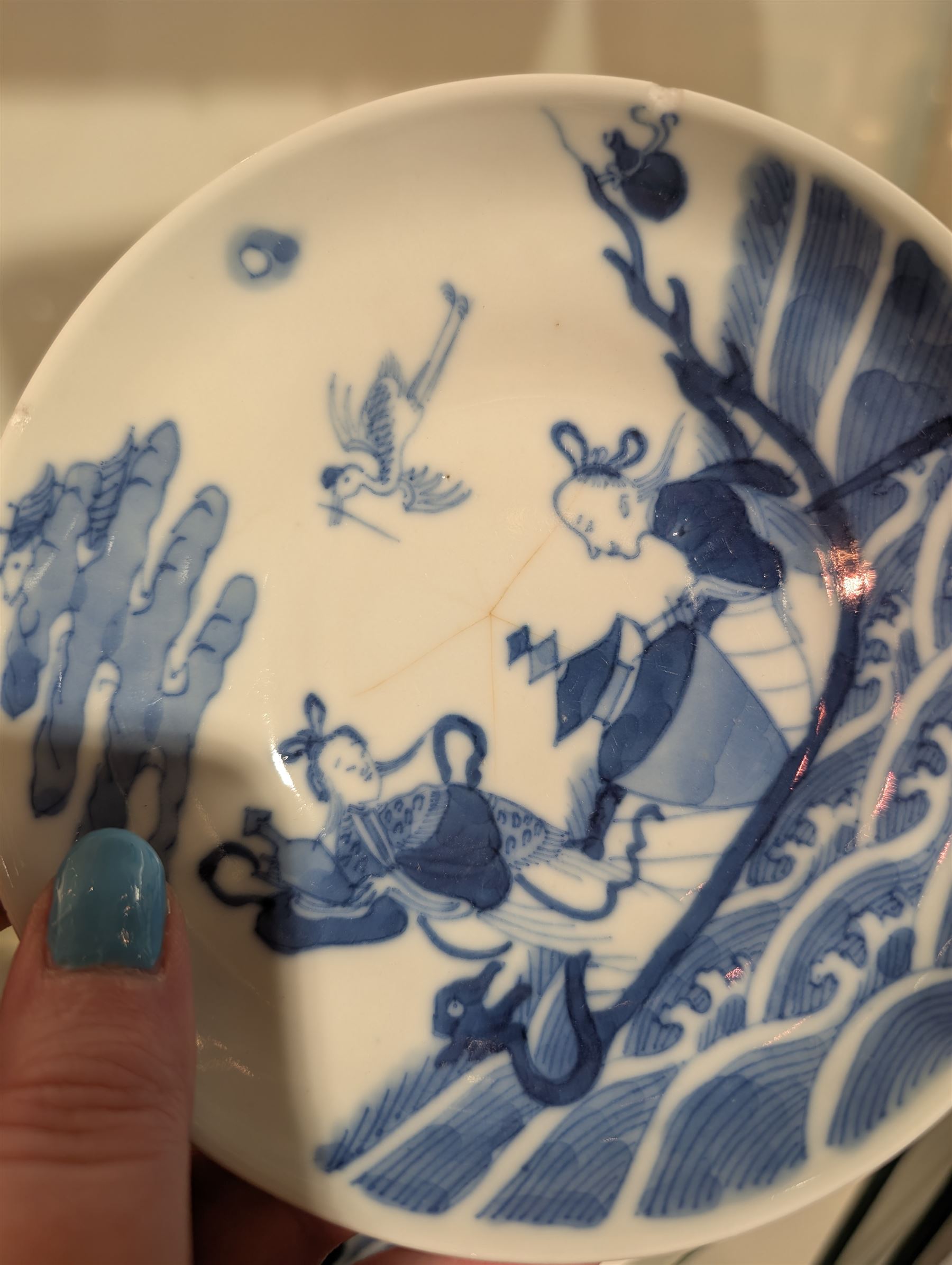 Pair of Chinese blue and white tea bowls, one with cover and four saucers, depicting two figures on a boat at sea, tea bowl H7cm