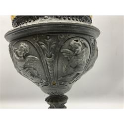 Victorian cast spelter oil lamp, decorated with cherubs and foliate scrolls, supporting a glass reservoir, burner and clear glass chimney, H62cm