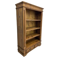 Solid pine open bookcase, fitted with four open shelves and two drawers