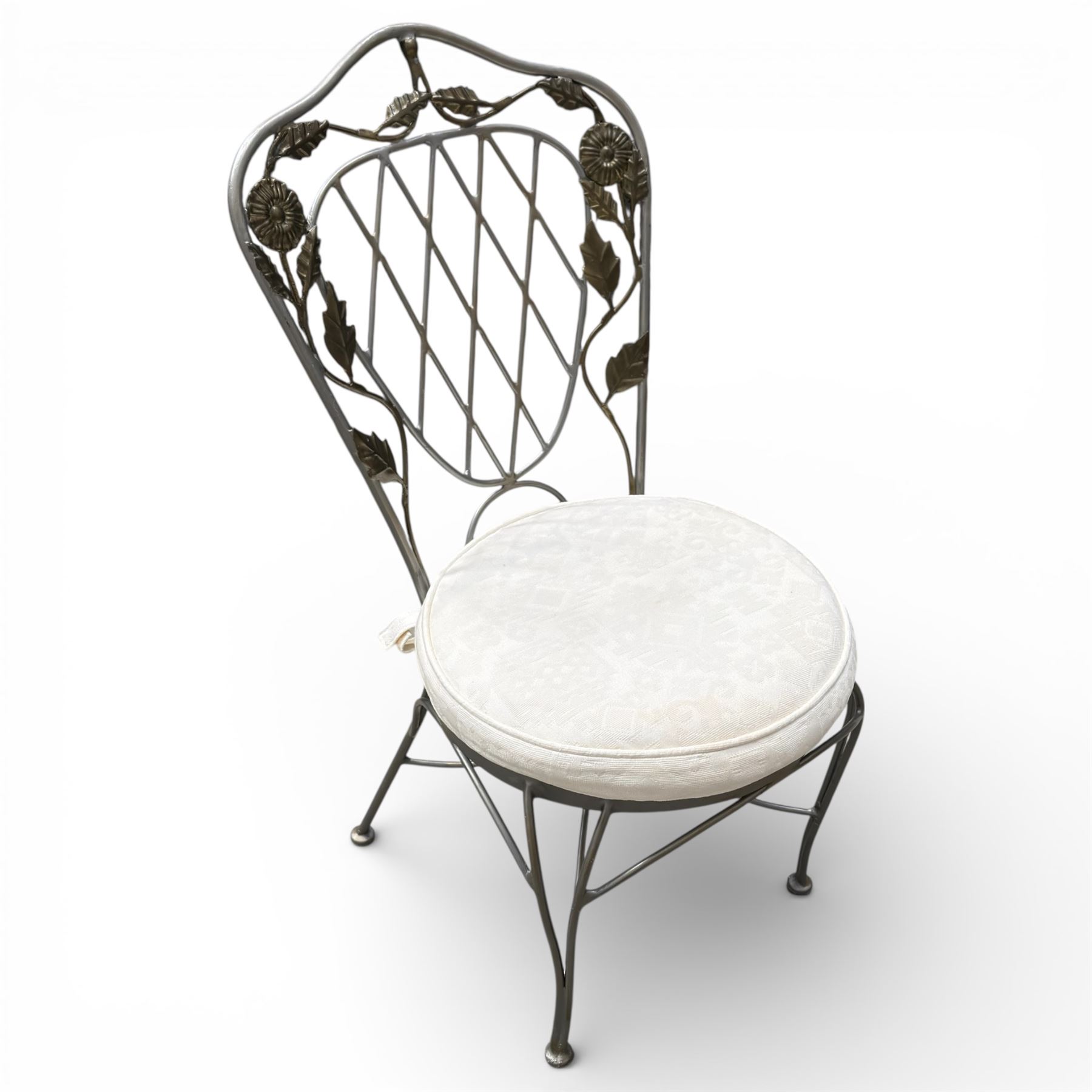 Wrought iron garden dining table with leaf decoration, and set of four matching chairs