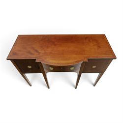 Regency period inlaid mahogany bow-breakfront sideboard, shaped rectangular top with crossbanding and ebony stringing, central convex frieze drawer flanked by cupboard and cellarette drawer, over fan-inlaid spandrels, raised on square tapering supports