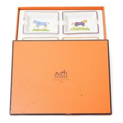 Hermès - set of four miniature porcelain ashtrays, each decorated with a horse in differing blanket, with gilt and coloured borders, in contrasting colour with various horse-coats, in original fitted box