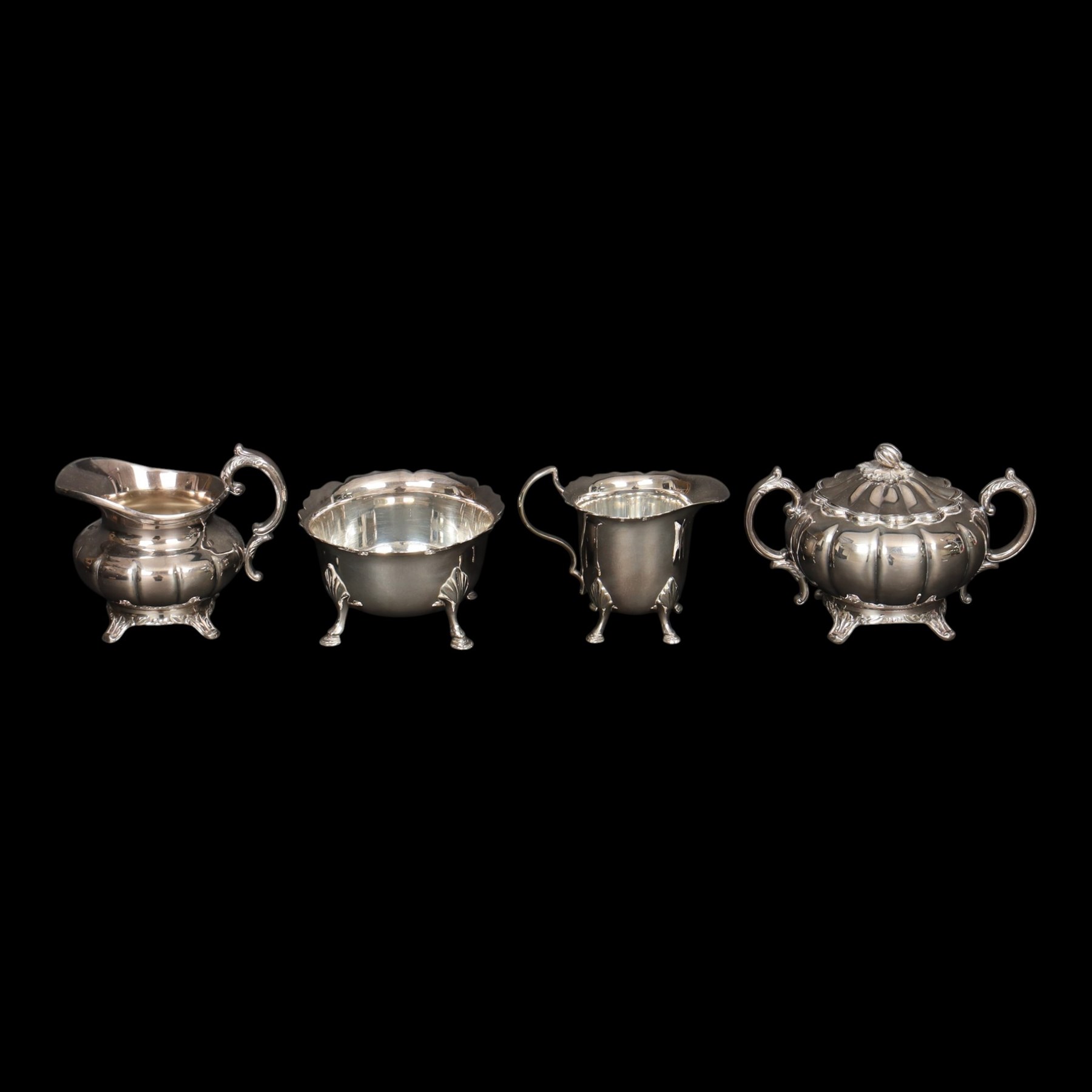 Silver plated four piece melon-shaped tea service by Viners Sheffield, comprising teapot, hot water jug, milk jug and covered sucrier, together with another silver plated tea service 