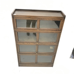 Mid 20th century oak sectional stacking library bookcase, four glazed compartments, platform base, W89cm, H139cm, D26cm