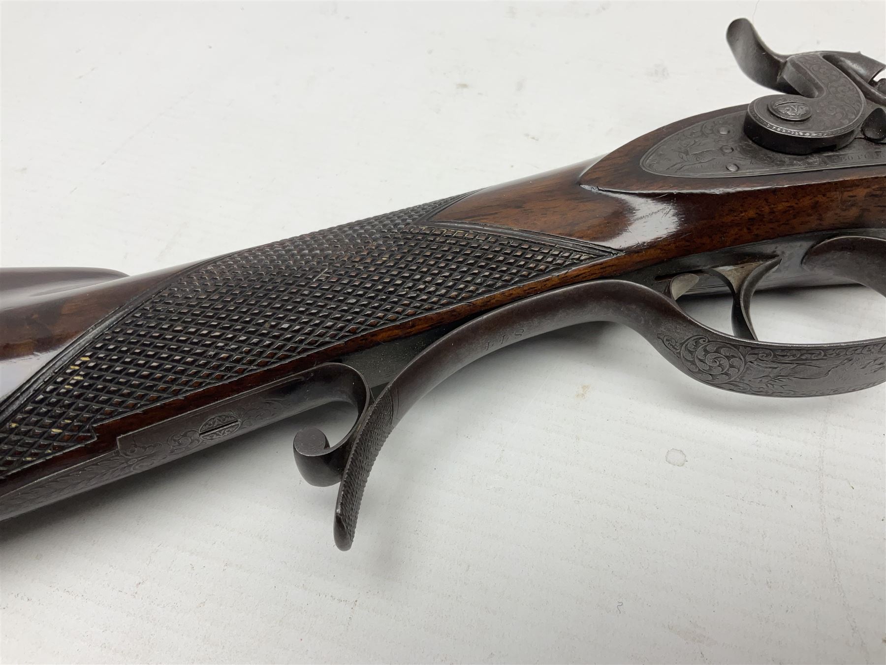 Mid-19th century percussion rifle by Geo. Forrest & Sons of Jedburgh No.844, 79cm octagonal barrel (approx .45 bore) with folding foresight, the lock plate with dolphin hammer finely engraved with a tiger and a stag, trigger guard engraved with hounds chasing a stag, figured walnut half stock with chequered grip and original ramrod 121cm overall; with framed photograph of original owner Dr. A.B. Dresser and archive of related ephemera including manuscript letter from the makers to Dr. Dresser regarding the sight specifications.