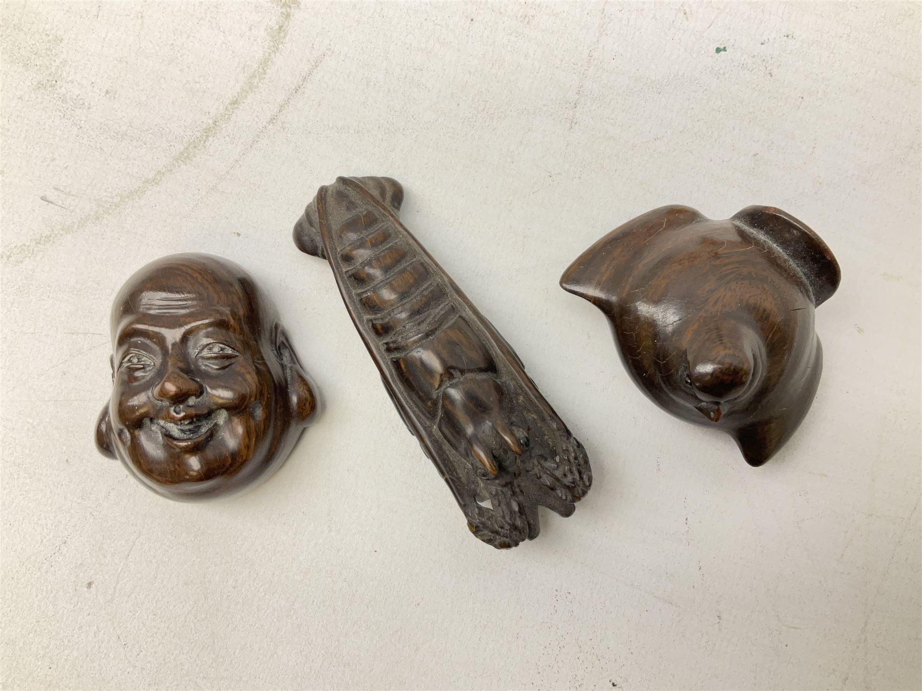 Group of ten Japanese netsukes, comprising eight carved wooden examples, and two ivorine examples, of various form, examples modelled as pigs, owl, mouse with tortoise upon its back, birds, rabbit, etc. 