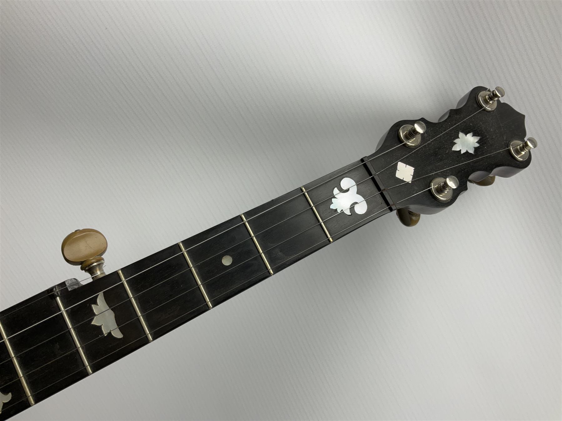 Five-string banjo by Clifford Essex Co. 15A Grafton Street, Bond Street, London W, with mother-of-pearl inlaid ebony fingerboard L92cm; in carrying case with strap