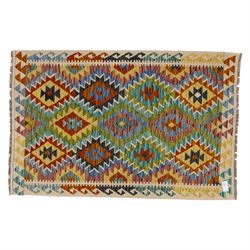Chobi flatweave kilim with a repeating stepped diamond medallion design in live green, rus...