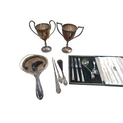Two silver mounted button hooks and a shoe horn, three silver handled knives, silver hand mirror mount, two silver plated trophies, etc 