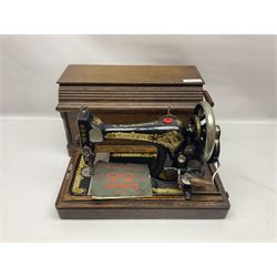 Singer 66 sewing machine in wooden case, together with an LG DVD player with speakers, two portable DVD players, etc 