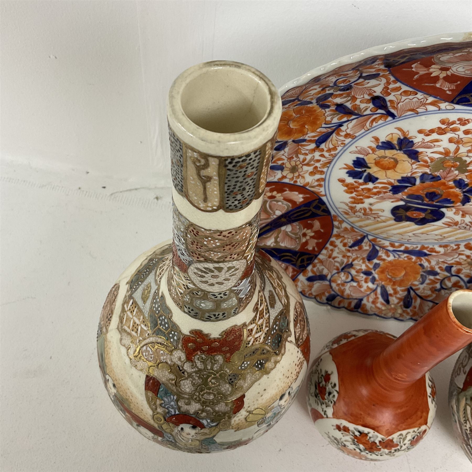 Collection of Japanese ceramics comprising pair of Satsuma vases decorated with panels depicting children and samurai figures, together with a Kutani vase painted with birds and flowers, all with painted character marks beneath, and an Imari plate, largest vase H31cm