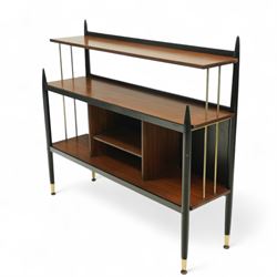 E Gomme for G Plan - 'Librenza' mid-20th century teak and ebonized wood bookcase, rectangular three-tier open shelf design with finials, narrow and raised top shelf above full span and depth central shelf, above divided shelf with open pigeonholes, sides with brass rods, raised on tapering legs with brass capped feet