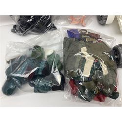 Action Man - large collection of 1960s and later figures and accessories including Spaceman with ATLRV vehicle; two figures marked 'Made in England by Palitoy under licence from Hasbro 1964'; twenty-five assorted weapons; radio backpacks; kit bags; twenty-one pairs of boots; football boots and snow shoes; metal diver's boots and three pairs of flippers; two pairs of jackboots; roller skates; various tunics, trousers, flying suits, jumpers, belts etc; twenty helmets, berets, busby, kepis, submariner etc; and quantity of other accessories