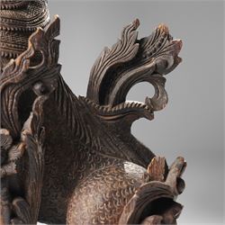 Burmese carved temple guardian figure, depicted seated with carved flame details, H52cm 