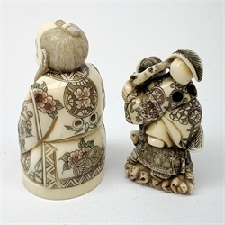 Two Japanese Meiji ivory netsukes, modelled as Fukurokuju, and a Fisherman, H6.5cm, (2)   