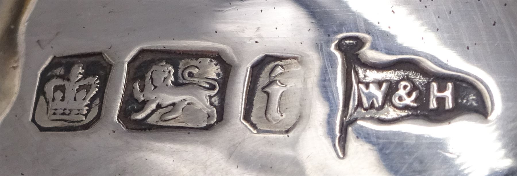 Pair of silver sauce boats, of typical plain form, with acanthus capped flying scroll handle and each upon three hoof feet, hallmarked Walker & Hall, Birmingham 1901, H9cm