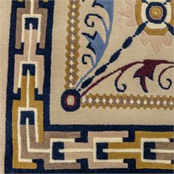 Rugs by Design - Nepalese wool rug, cream field decorated with repeating diamond trellis enclosing scrolling foliate motifs in blue, burgundy and ochre, within chain-link border and fringed ends