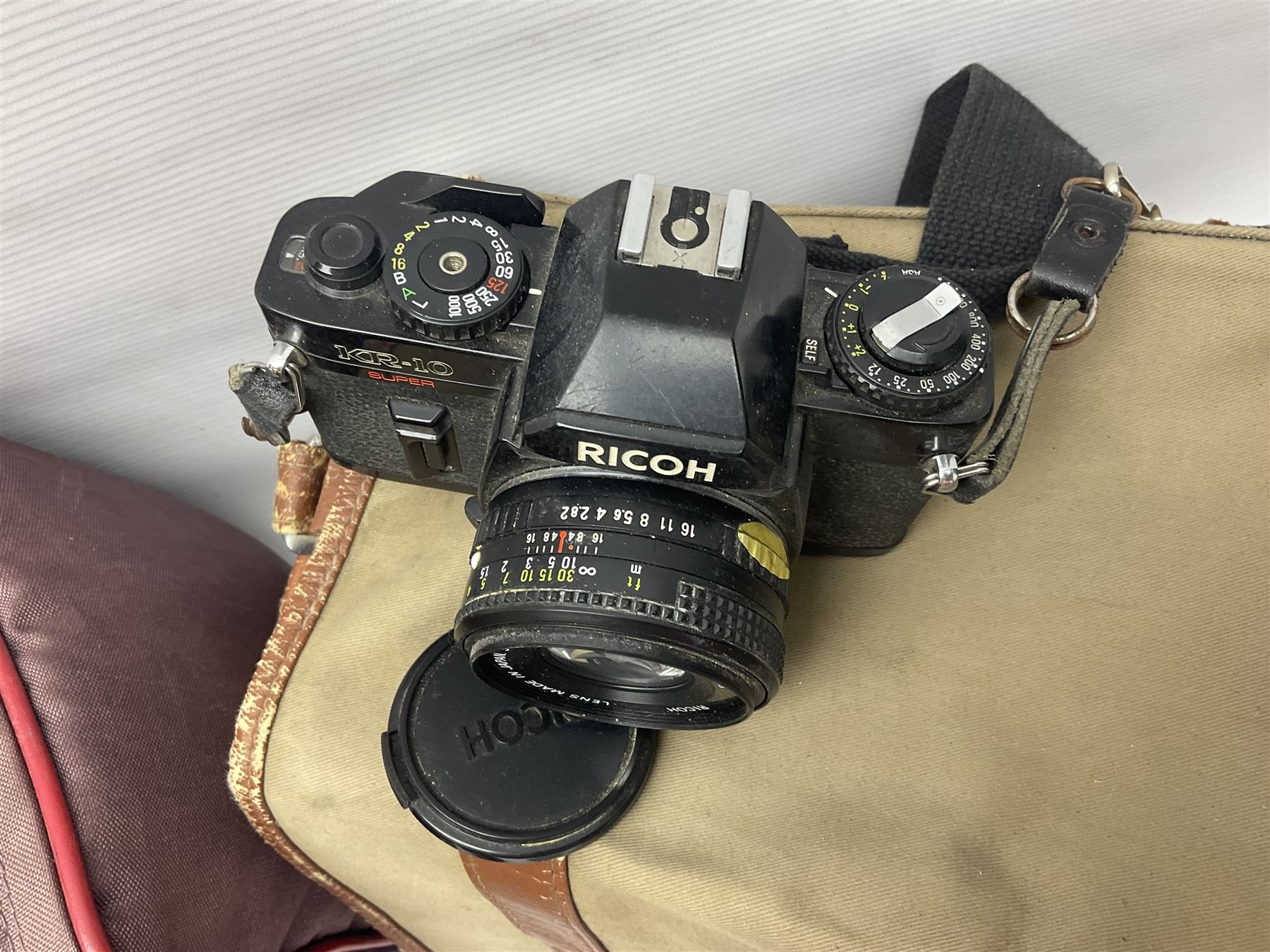 Cameras and accessories, to include Olympus OM101 Power Focus camera body, serial no 1076067, with 'Sigma AF Zoom 1:38, f=75 200mm' lens, serial no 2053714, Canon EOS 5000 camera body, serial no 1507812, with 'Canon Zoom EF 80-200mm, 1:4.5-5.6' lens, other cameras, by Miranda, Coronet and Ricoh and a collection of lenses, carry cases, etc 