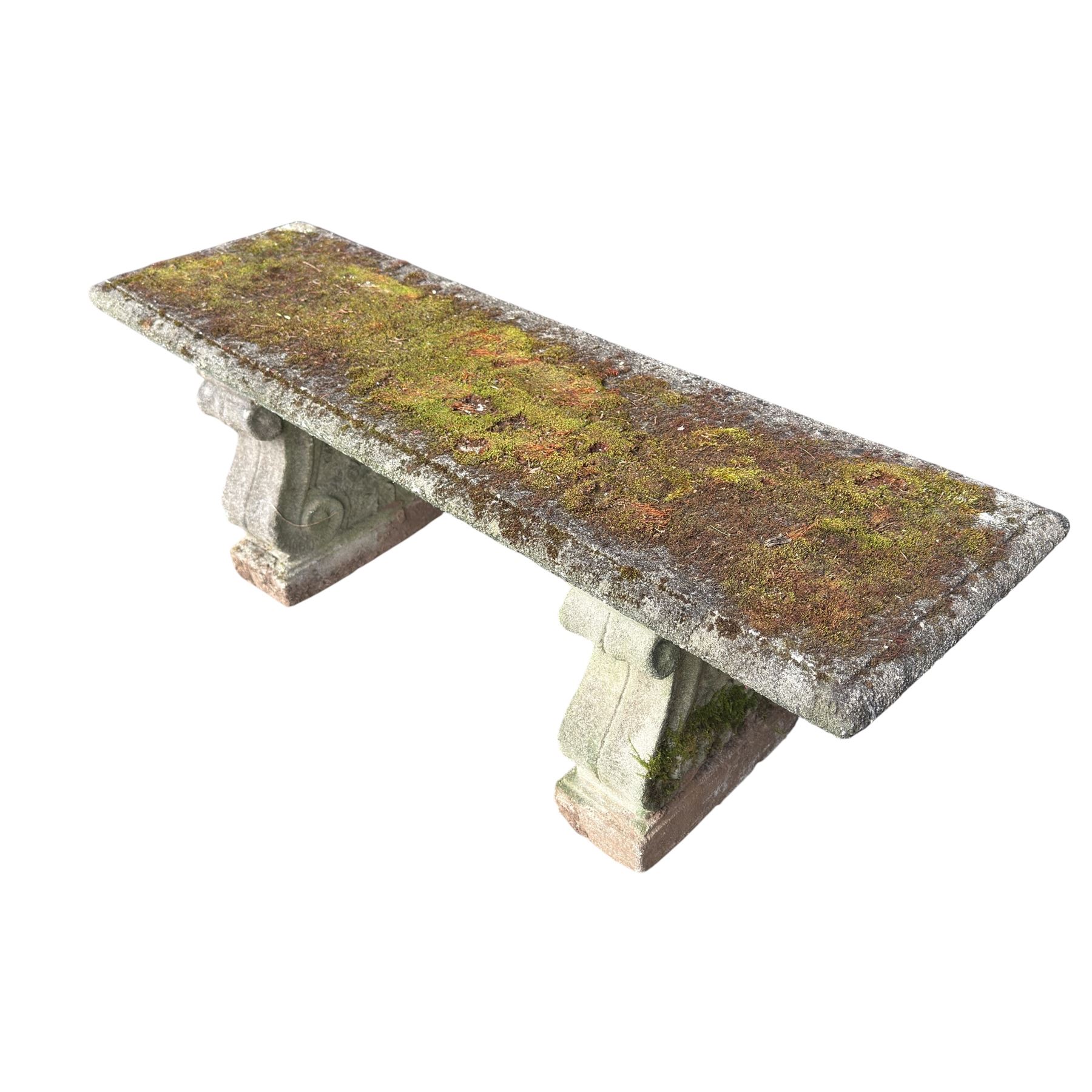 Weathered cast stone three piece bench, the rectangular seat with moulded edge, raised on Neoclassical style end supports with S-scrolls and fruiting grapevines, on rectangular bases
