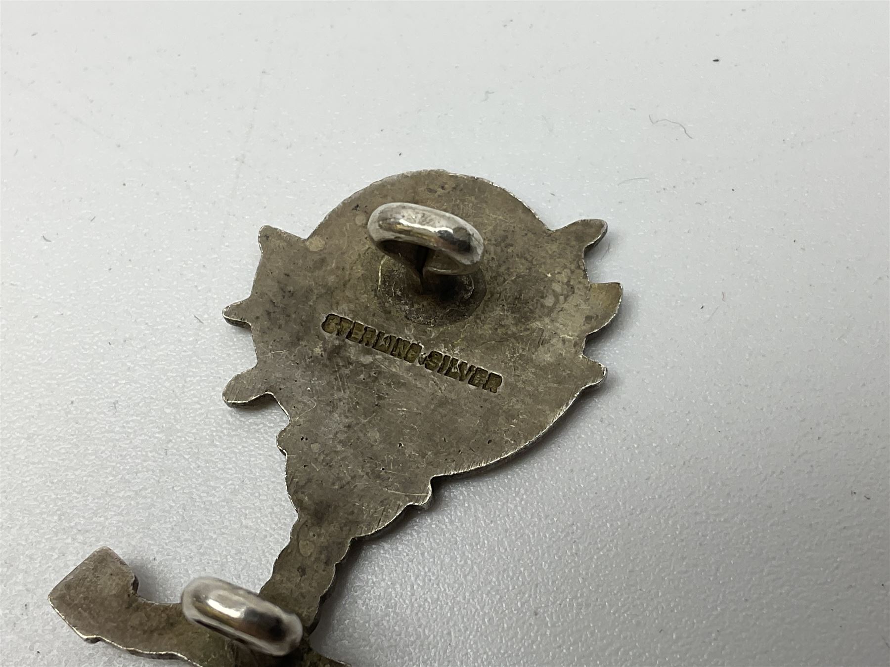 Popski's Private Army sterling silver cap badge; and two silver sweetheart brooches for Highland Light Infantry as a rifle and silver gilt Glengarry badge and Army Service Corps with blue enamel; and another silver badge (4)