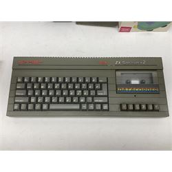 Sinclair ZX Spectrum +2 128k, Sinclair joystick, RAM Turbo joystick add-on, Comcon joystick interface, Power Supply Unit, unassociated multi-colour joystick, original instruction manual and a quantity of mostly Spectrum 48k games
