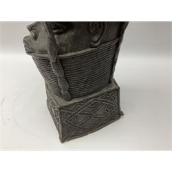 20th century Benin bronze head of an Oba, donning headdress and neck rings with wide open eyes, raised upon a tapering square base, the sides with relief cast knot decoration, H39cm